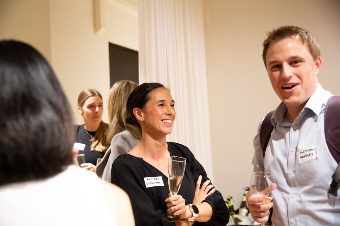 Wellshare practitioners talking at a community networking event